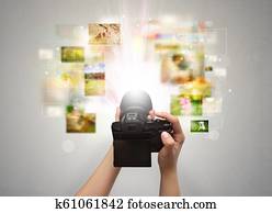 Hand captures life events with digital camera