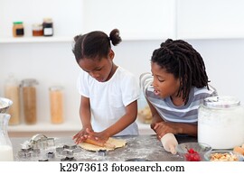 Jolly siblings cooking biscuits