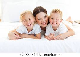 Animated children and their mom having fun lying Animated children and their mom having fun lying