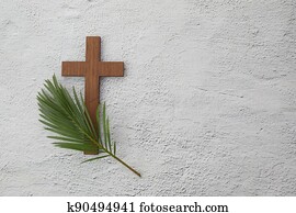 Palm sunday background. Cross and palm on grey background.