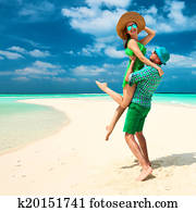 Couple in green on a beach at Maldives Couple in green on a beach at Maldives