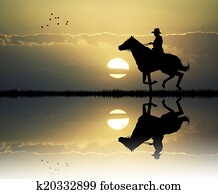 cowboy with lasso at sunset cowboy with lasso at sunset