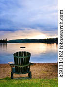 Wooden chair at sunset on beach