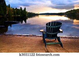Wooden chair at sunset on beach