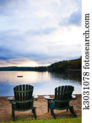 Wooden chairs at sunset on beach