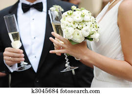 Bride and groom holding champagne glasses Bride and groom holding champagne glasses