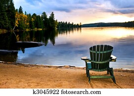 Wooden chair at sunset on beach