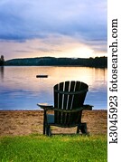 Wooden chair at sunset on beach