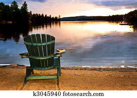 Wooden chair at sunset on beach