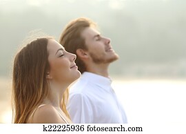 Couple of man and woman breathing deep fresh air