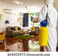Asian man in PPE disinfection from COVID-19 at home Asian man in PPE disinfection from COVID-19 at home