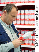 Elderly person selects goods in food store
