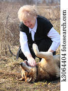 Elderly woman caresses dog