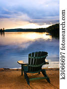 Wooden chair at sunset on beach