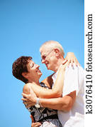 Mature couple on blue sky background