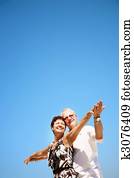 Mature couple on blue sky background Mature couple on blue sky background