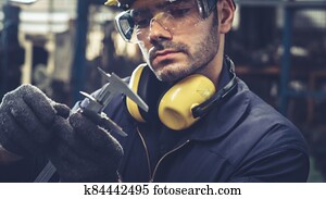 Smart factory worker using machine in factory workshop Smart factory worker using machine in factory workshop
