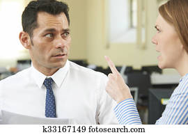 Aggressive Businesswoman Shouting At Male Colleague