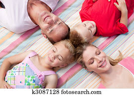 Loving family sleeping lying on the grass Loving family sleeping lying on the grass