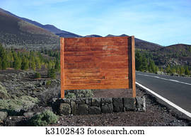 Blank wooden sign next to road