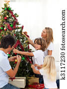 Happy family decorating Christmas tree
