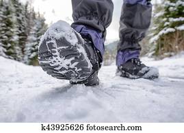 Hiking boots in snowy forest Hiking boots in snowy forest