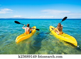 Man and Woman Kayaking in the Ocean Man and Woman Kayaking in the Ocean
