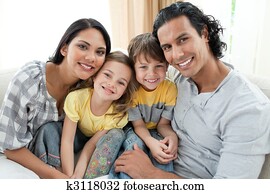 Portrait of a smiling family sitting on sofa