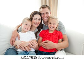 Portrait of happy family sitting on sofa