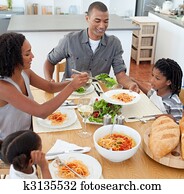 Jolly family dining together