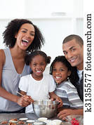 Jolly family making cookies together