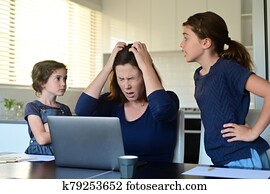 Upset mother forced to work from home as the pandemic coronavirus (COVID-19) forces many employees to work from home. Upset mother forced to work from home as the pandemic coronavirus (COVID-19) forces many employees to work from home.