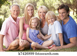 A family, with parents, children and grandparents, relaxing in a park A family, with parents, children and grandparents, relaxing in a park