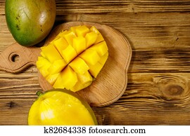 Fresh mango fruit on wooden table Fresh mango fruit on wooden table