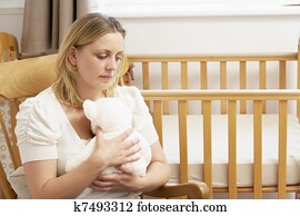 Sad Mother Sitting In Empty Nursery Sad Mother Sitting In Empty Nursery