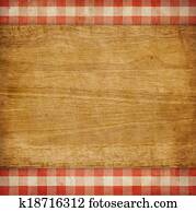Cutting board over red grunge checked gingham picnic tablecloth background
