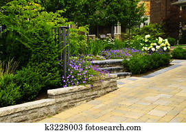 Landscaped  garden and stone paved driveway