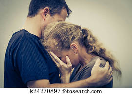 Sad woman hugging her husband Sad woman hugging her husband
