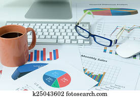 business charts or graphs and coffee with eyeglasses business charts or graphs and coffee with eyeglasses
