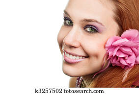 Happy woman with flower at ear isolated on white