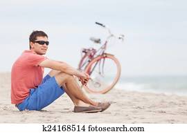 man biking at the beach