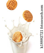 Three cookies biscuits falling into a glass mug full of fresh milk, splashing. close up view, On white background, with clipping path included. Three cookies biscuits falling into a glass mug full of fresh milk, splashing. close up view, On white background, with clipping path included.