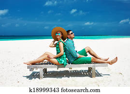 Couple in green on a beach at Maldives Couple in green on a beach at Maldives