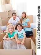 Smiling family packing boxes