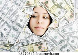 woman looking trought hole on money bacground