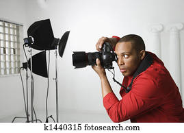 Man photographing in studio.
