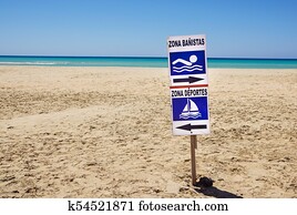 sign of bathing area on the beach for the safety of bathers compared to boats . 