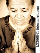 Christian senior woman praying to God