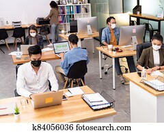 Social distance office with business team wear face mask as new normal life Social distance office with business team wear face mask as new normal life