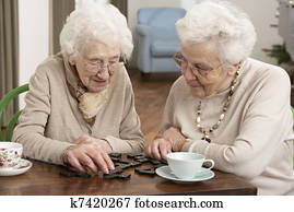 Two Senior Women Playing Dominoes At Day Care Centre Two Senior Women Playing Dominoes At Day Care Centre